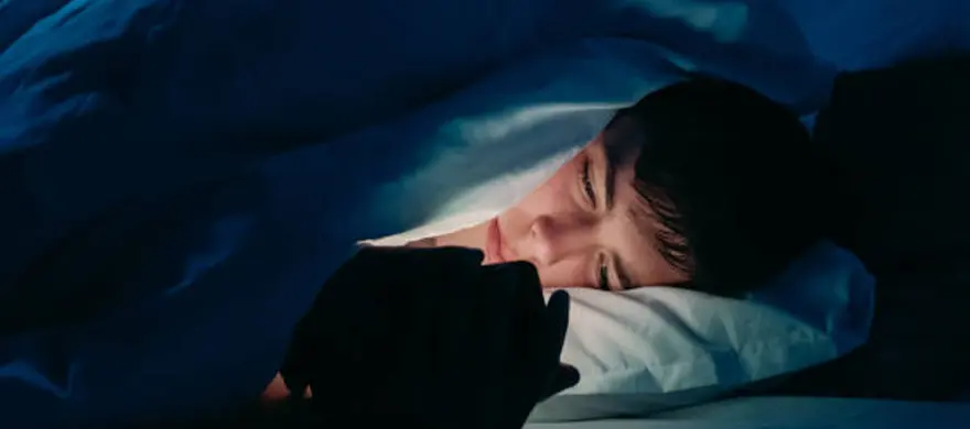 Person scrolling phone alone at night